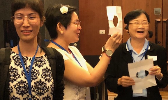 People holding paper cut-outs